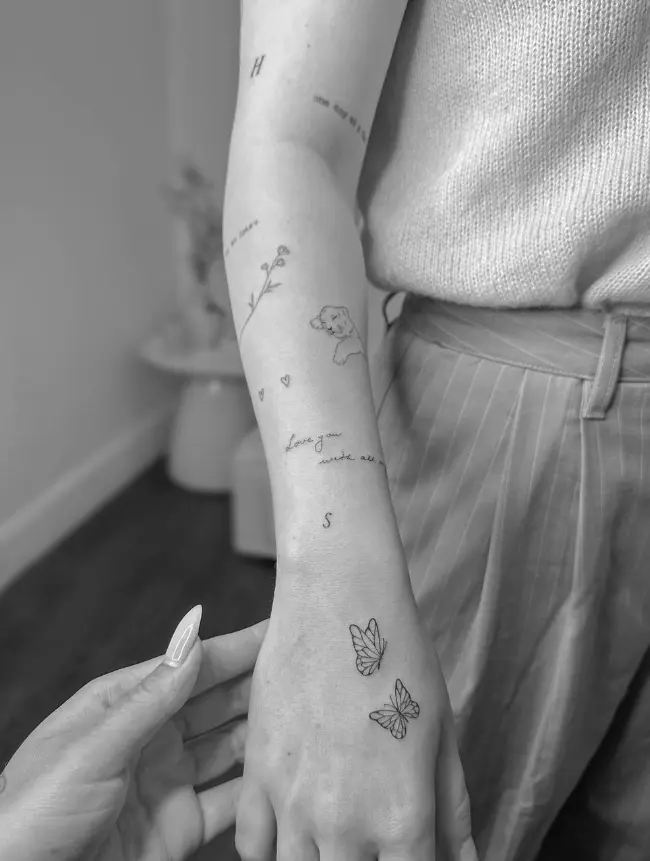 Fine line arm tattoo collection with butterflies, flower stem and script elements by Chelsea.Q